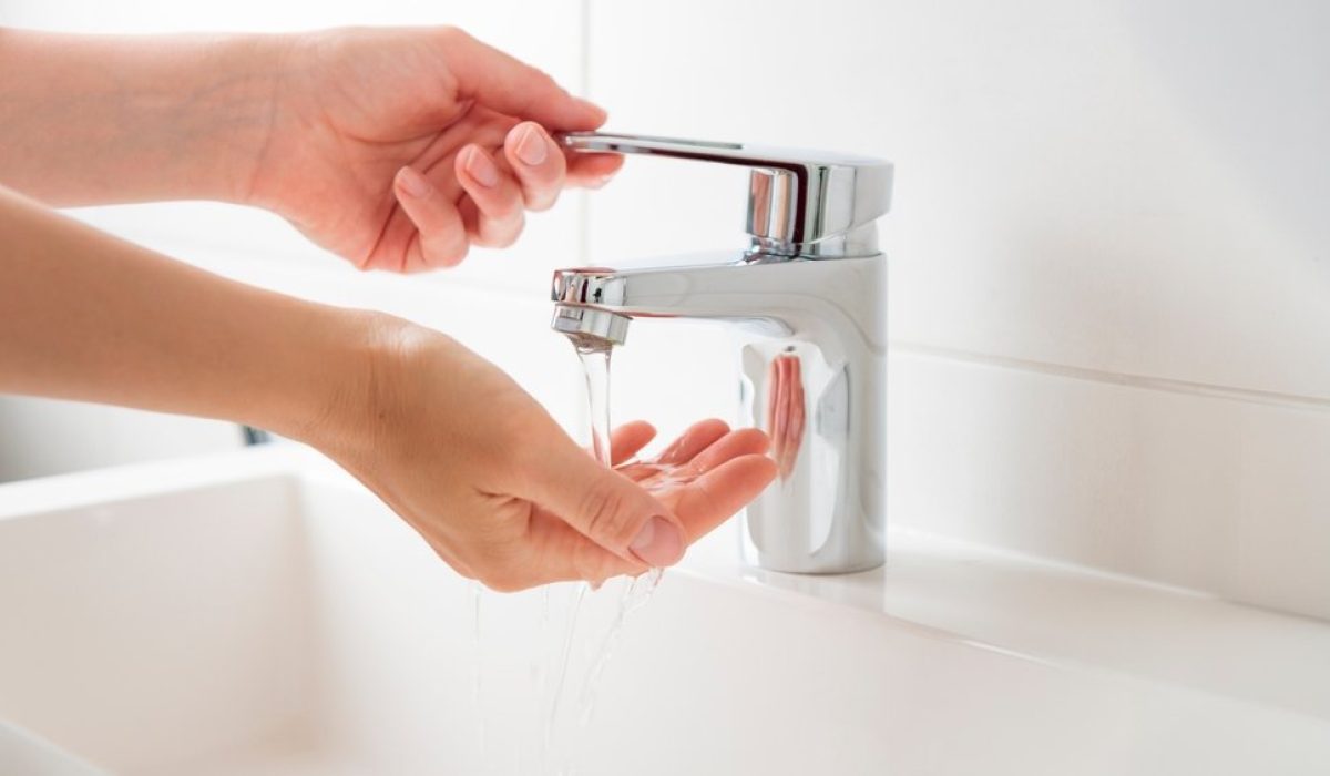 Banner,With,Woman,Opening,Flow,Tap,And,Trying,Water,Temperature.