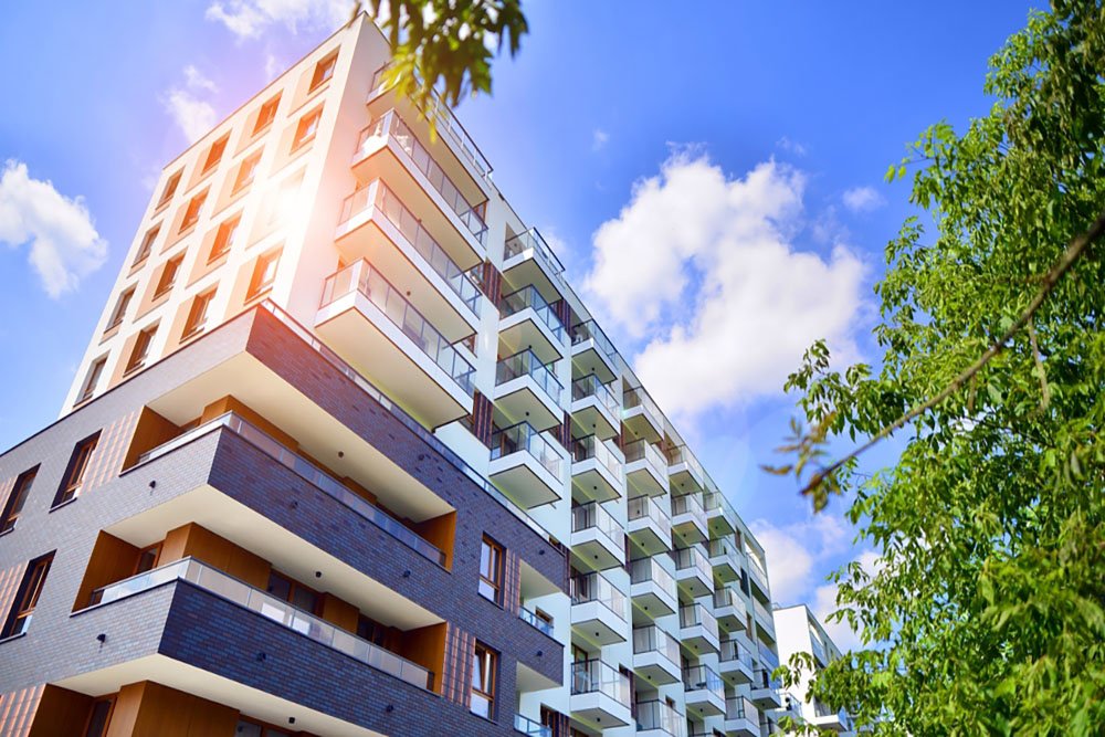 European residential architecture harmonizing with nature. Eco-friendly living in city with greens. Eco apartment building saving energy and fresh air concept.